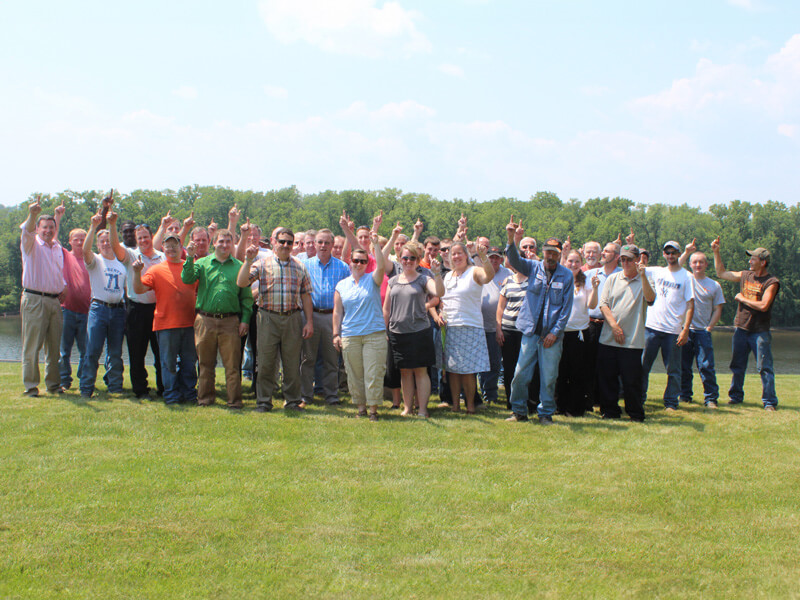 fort miller associates gathered in field celebrating
