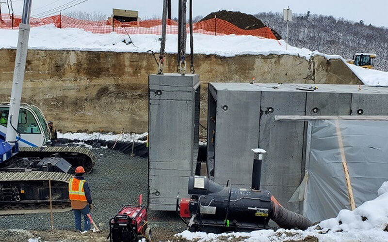 fort miller installing four-sided precast culvert units on highway