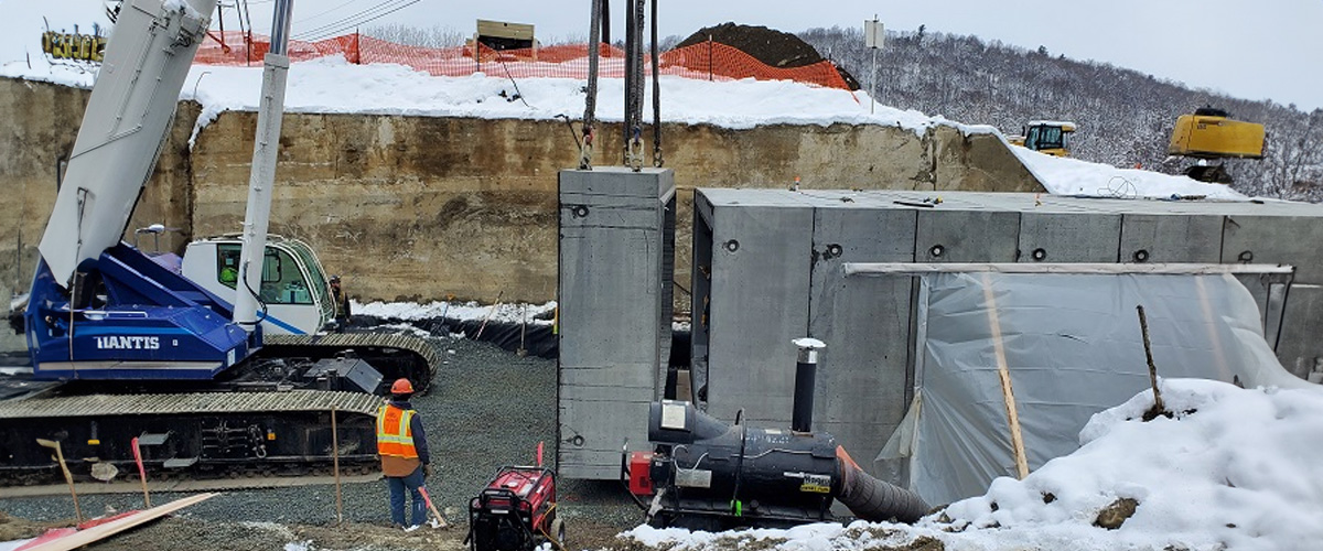 fort miller installing four-sided precast culvert units on highway