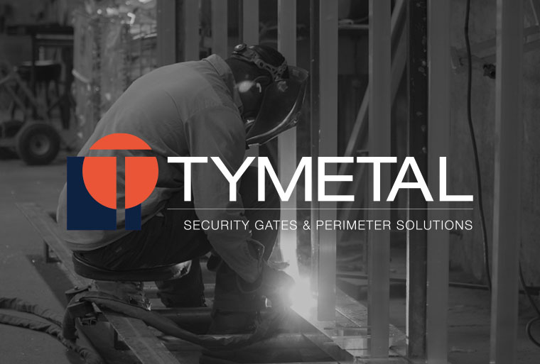 man welding metal in warehouse