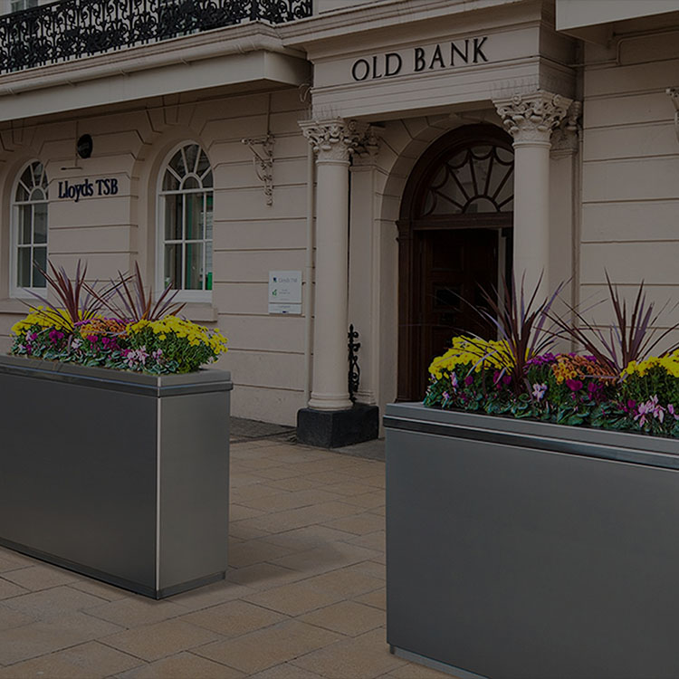 tymetal crash planter in front of bank